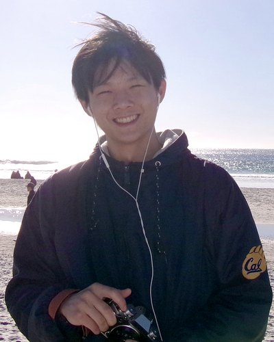 Max on a beach holding a camera